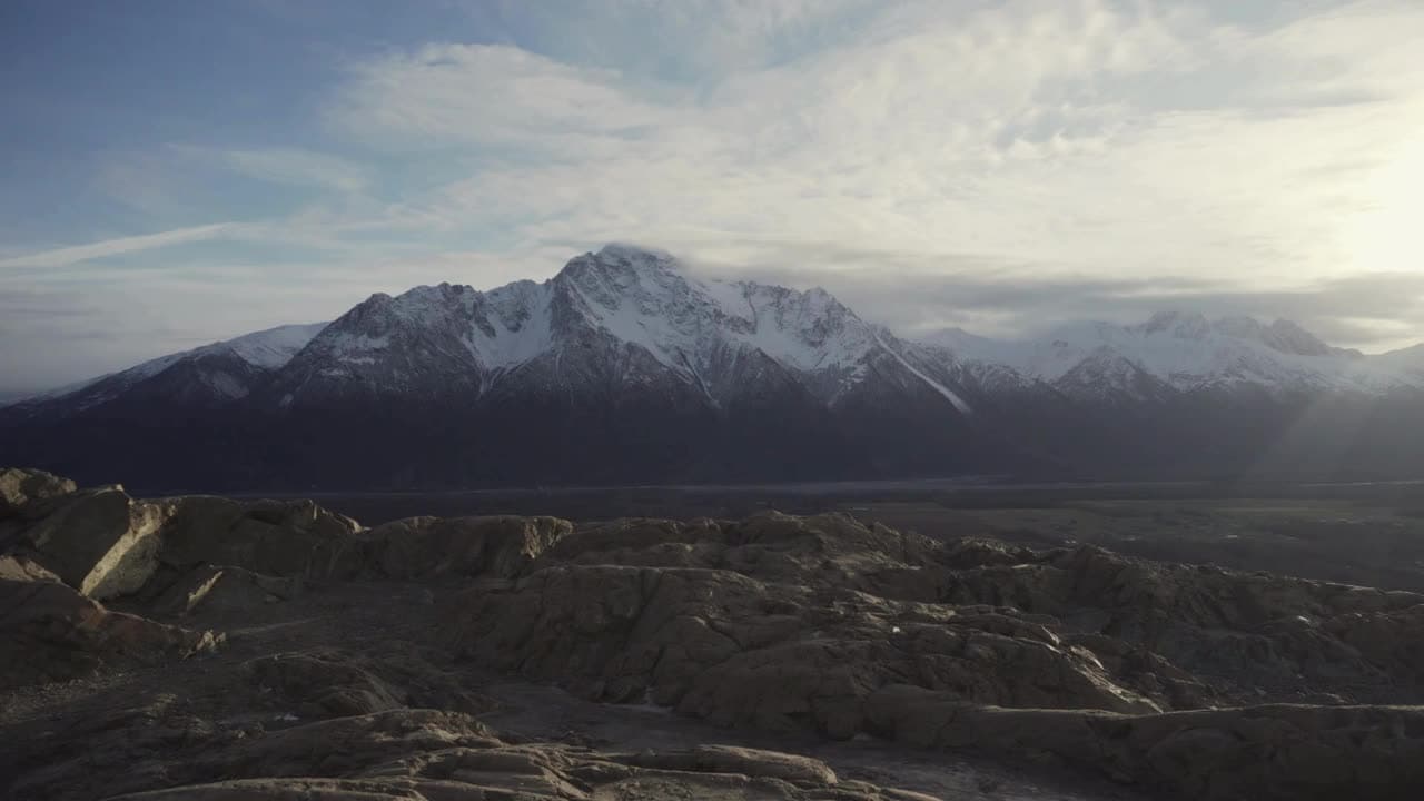 Man overlooking Alaska's mountain range.