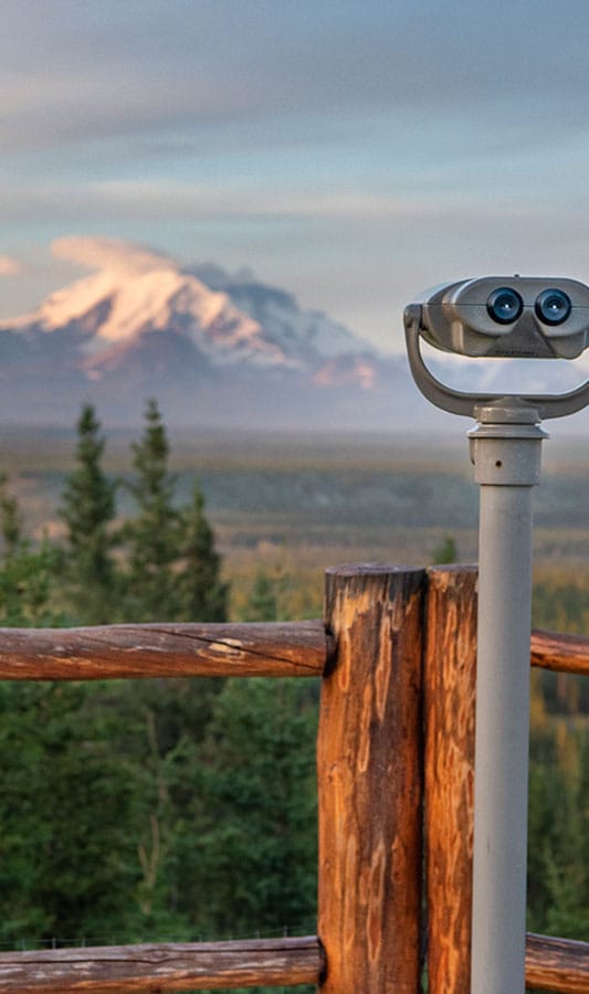 Viewing Binoculars overlooking Wrangell-St. Elias National Park at Copper River Princess Wilderness Lodge