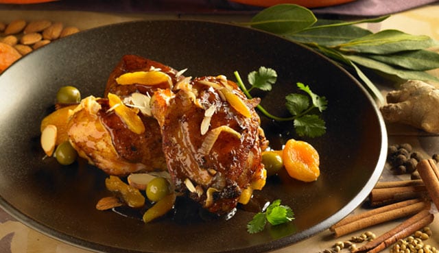 Cornish game hen, garnished with dried fruits and olives