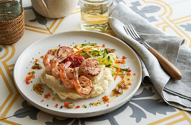 Shrimp and scallop on a bed of mashed potatoes dish
